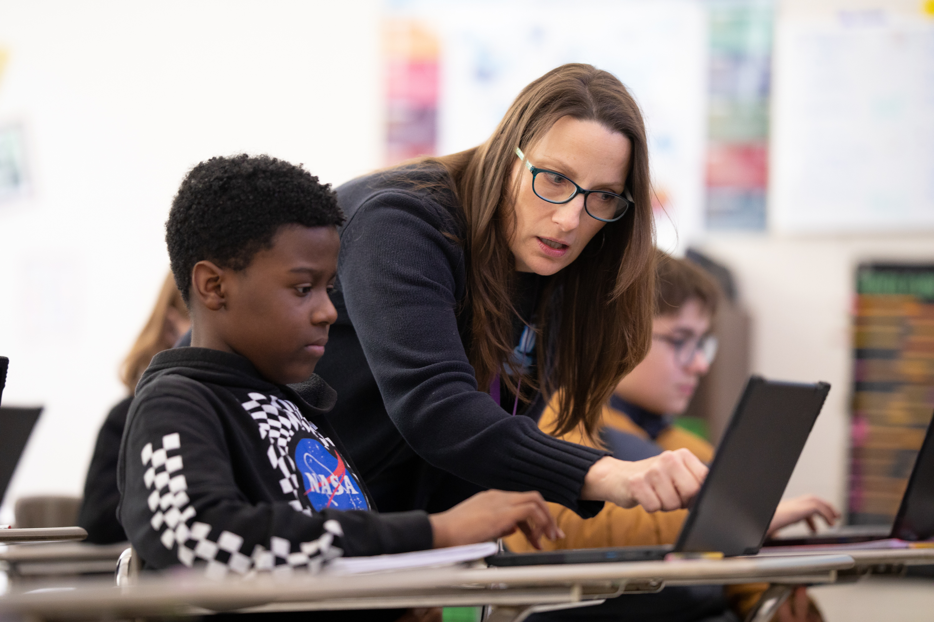 student and teacher on laptop