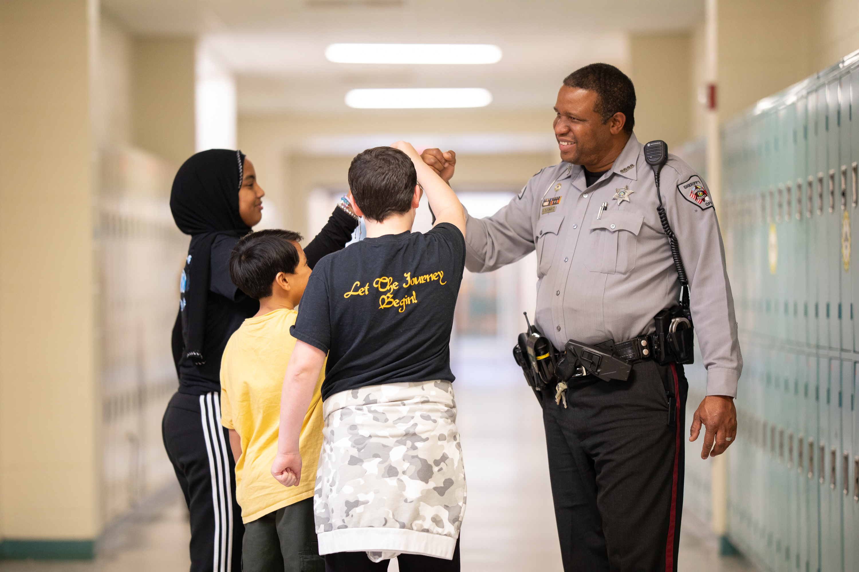 SRO fist-bumping students