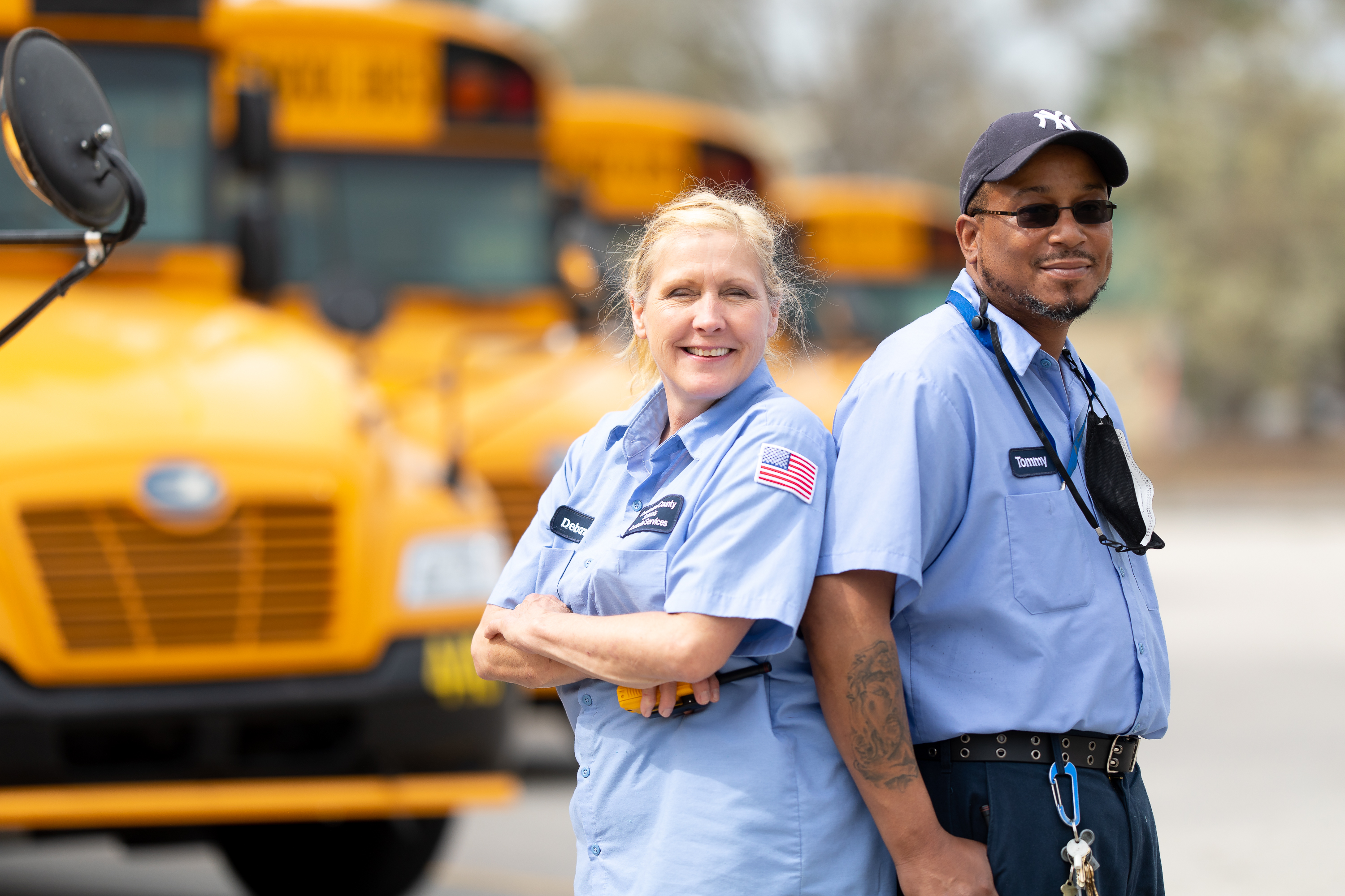 CCS Staff in front of buses