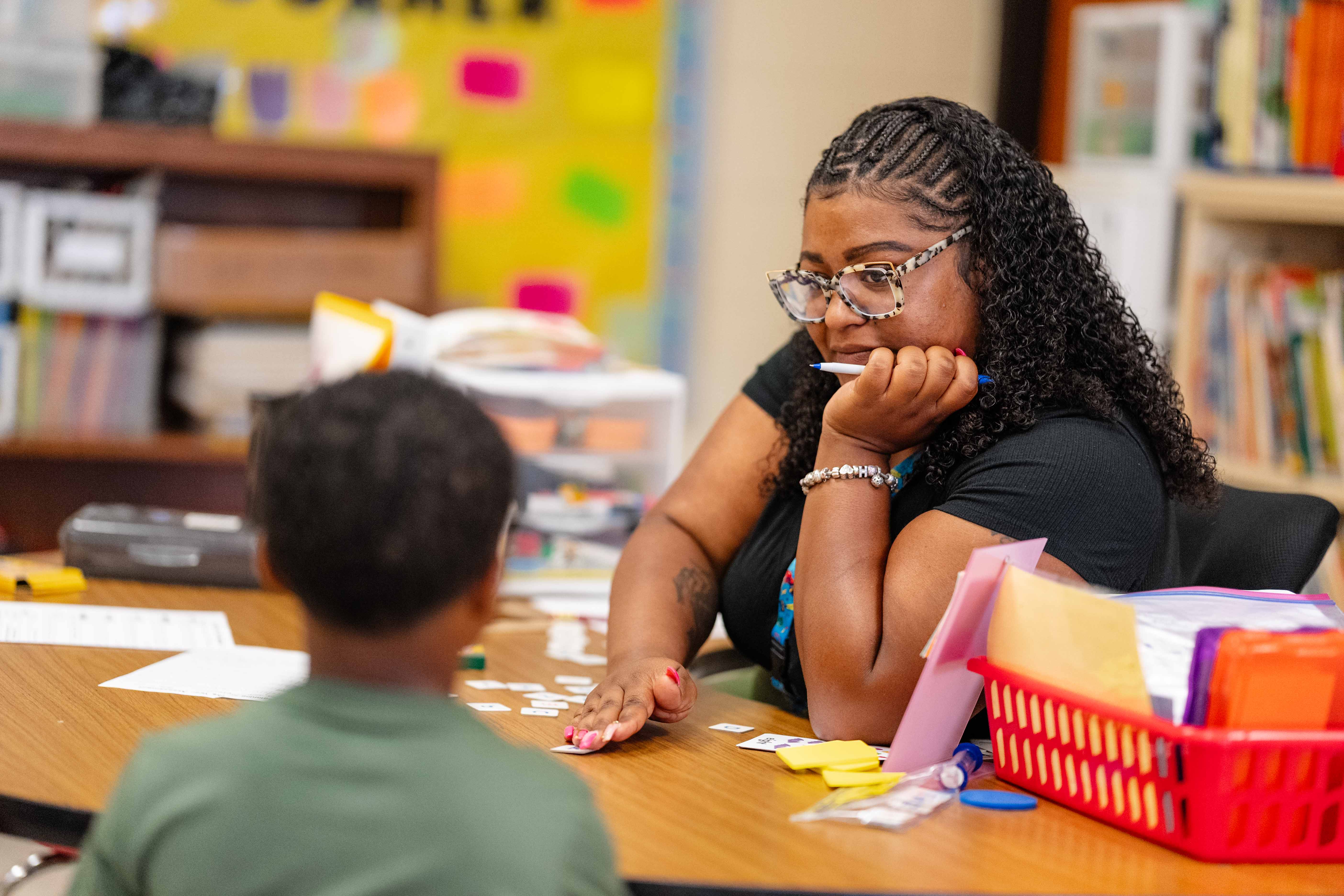 Teacher working with a student.