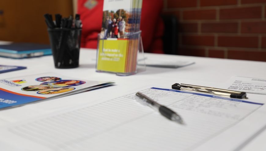 Sign-in Table with Pens and Clipboard