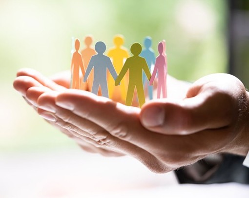 Hands holding cutout of children