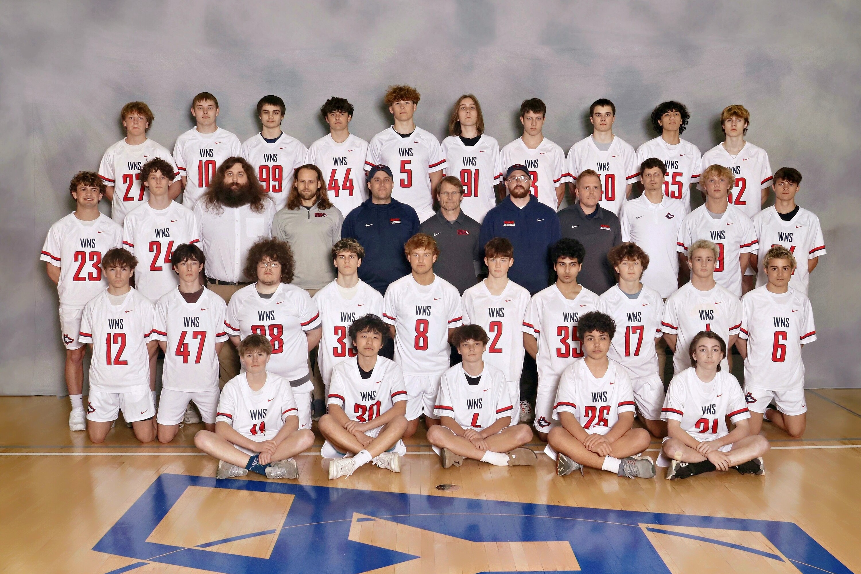 varsity boys lacrosse posing for team picture