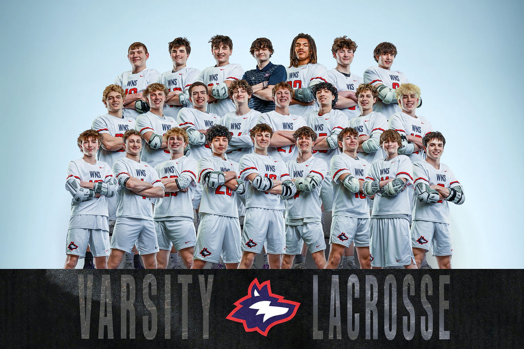 A team photo of players in white uniforms and gloves, standing in a group with their arms crossed.