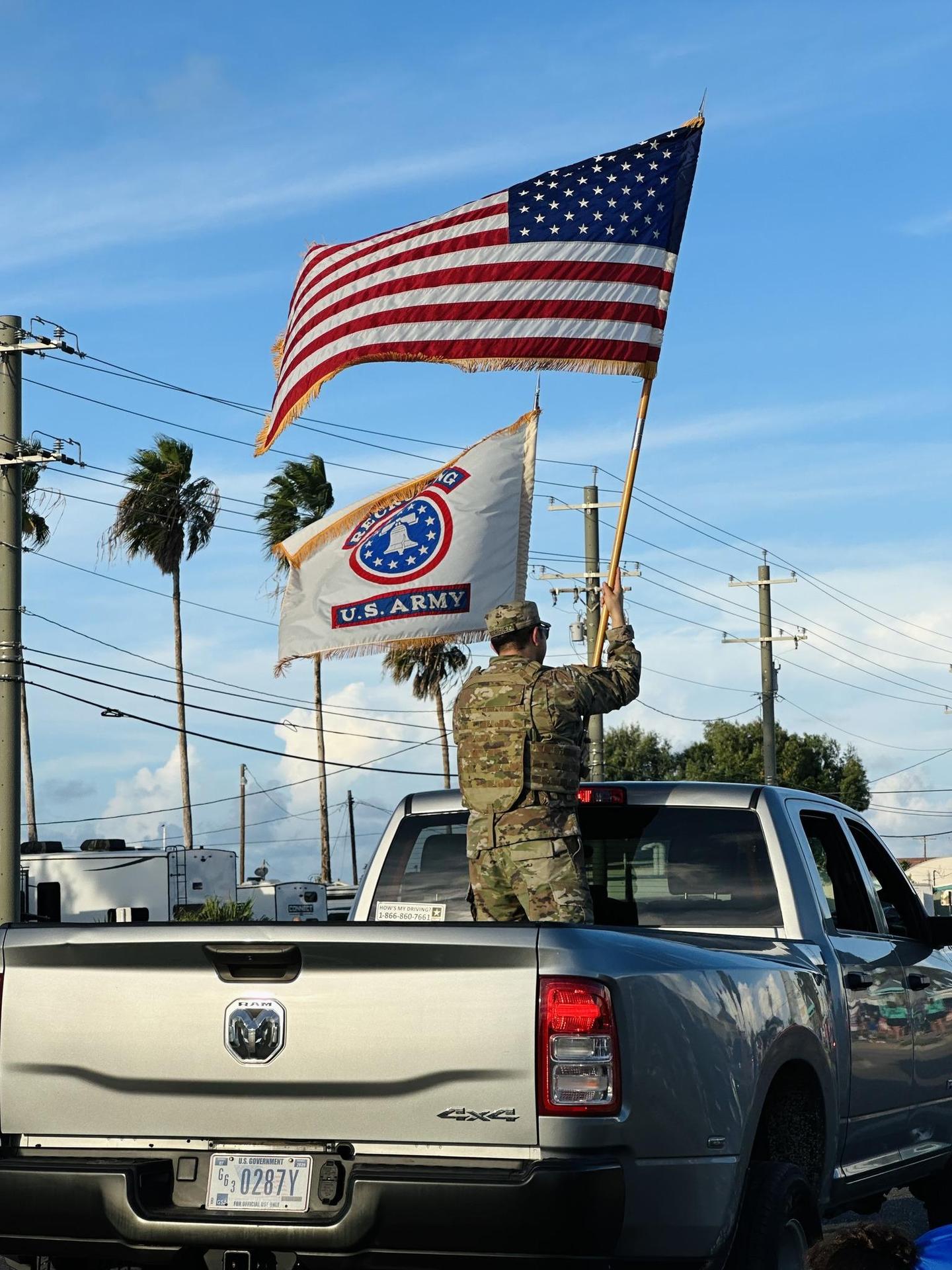 Military men holding an american flag