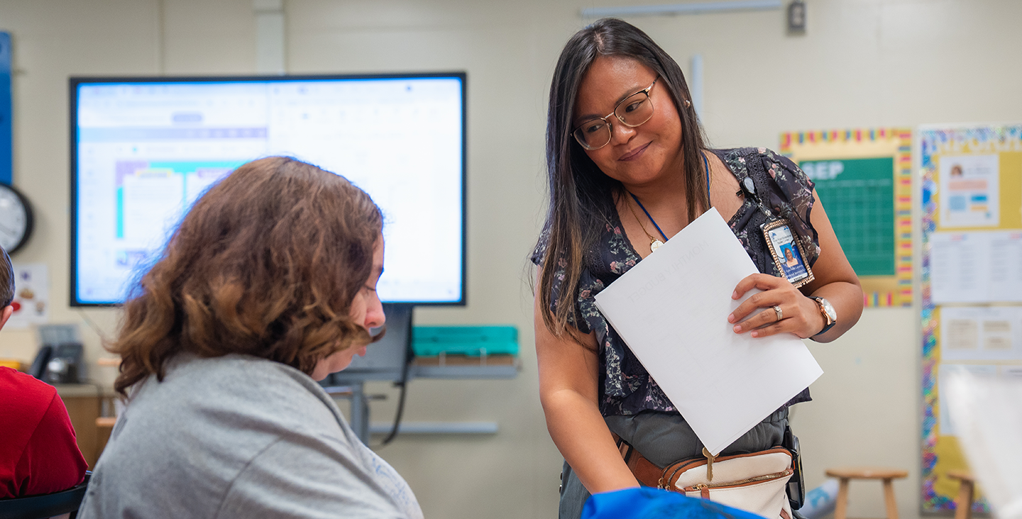 teacher working with a student