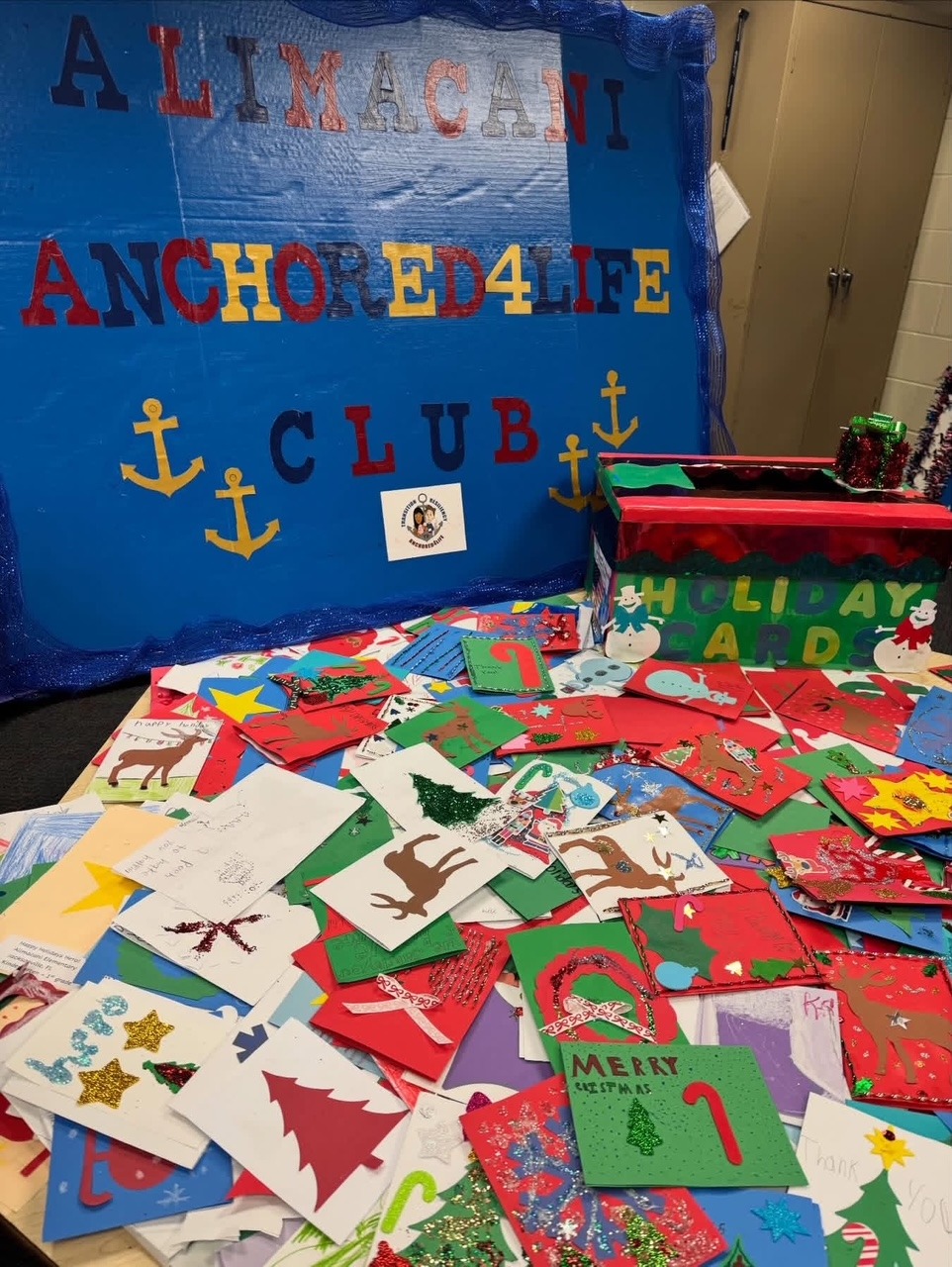 Alimacani Anchored4Life banner with a collection of handmade winter holiday cards.