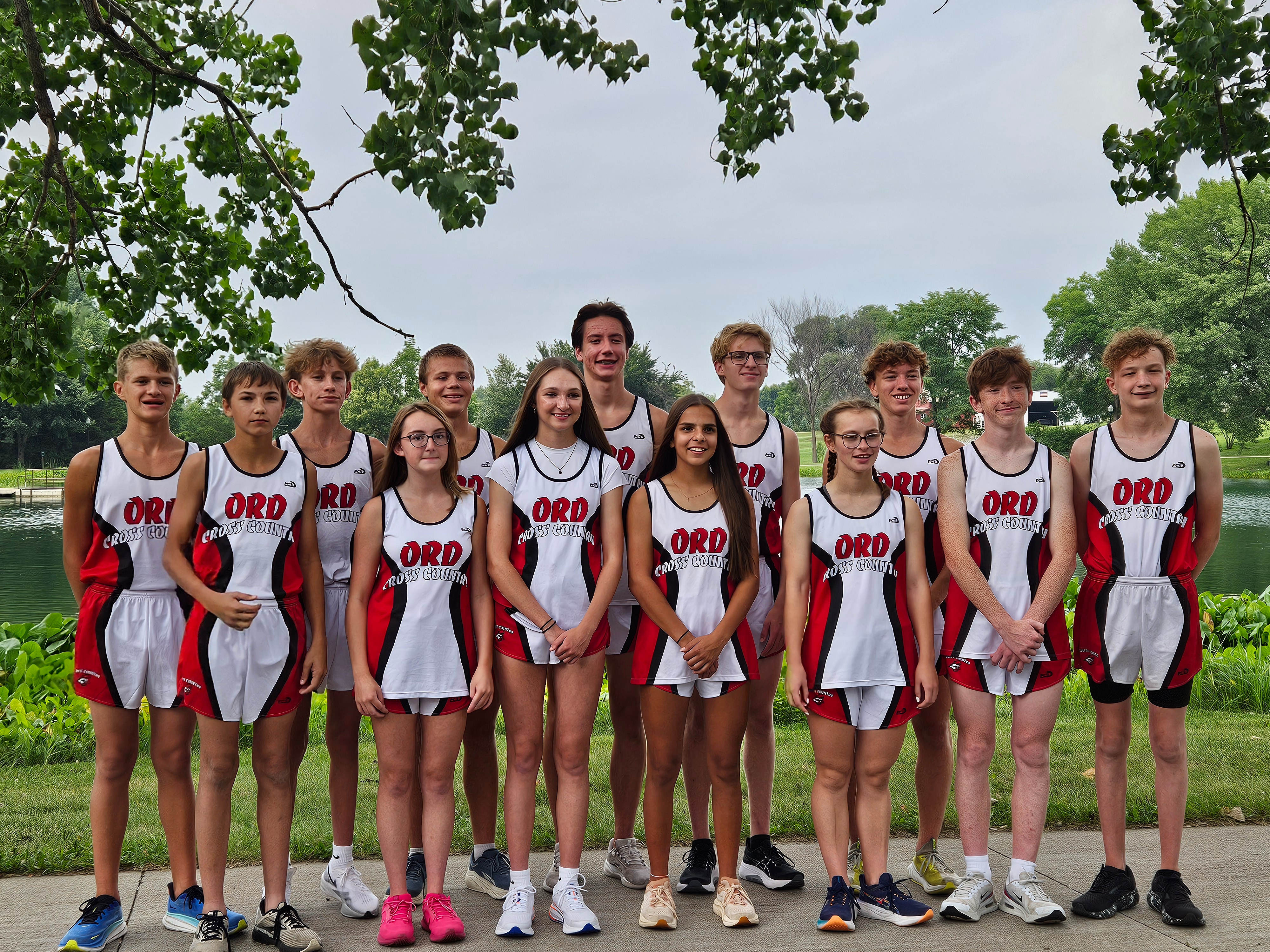 A photo of the Cross Country group along with the Head Coach and Assistant Coach