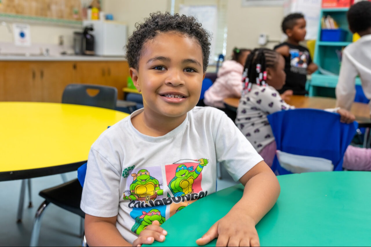 A student smiling at the camera