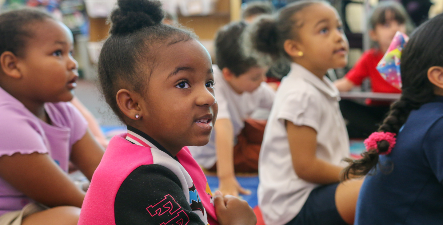 Students sitting on the floor listening