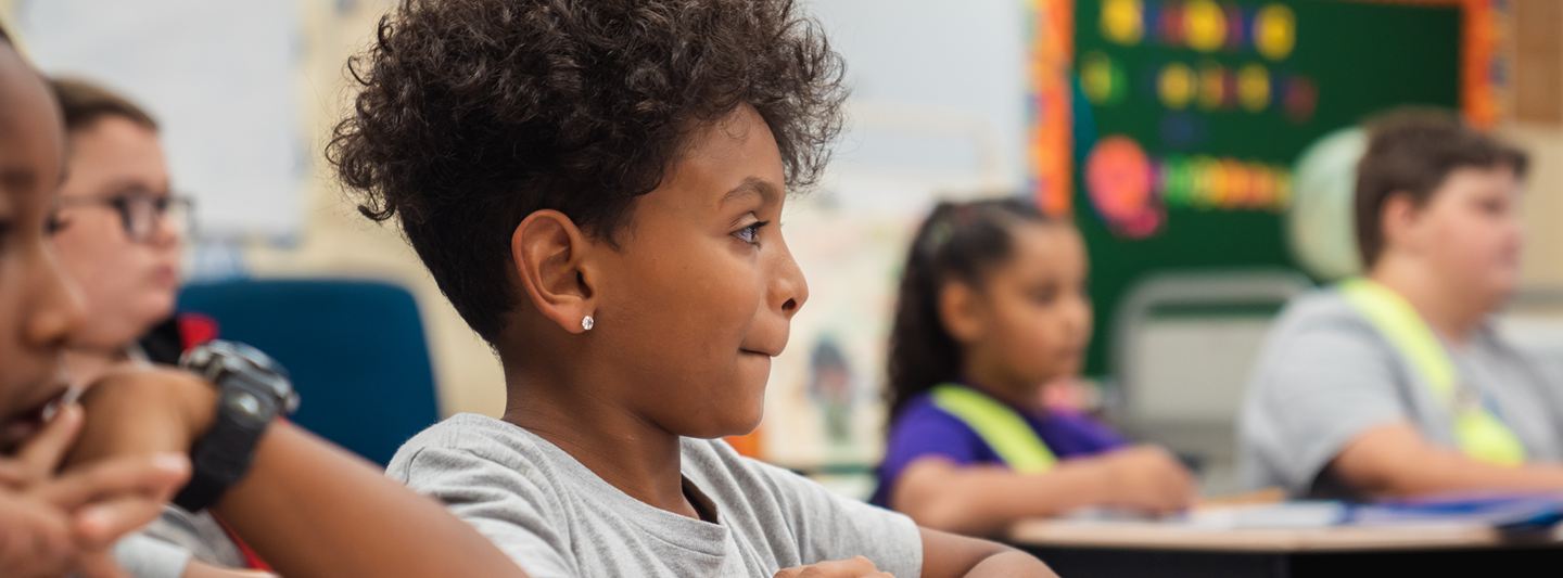 students in classroom listening to their teacher