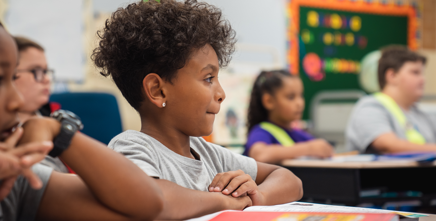 students in classroom listening to their teacher