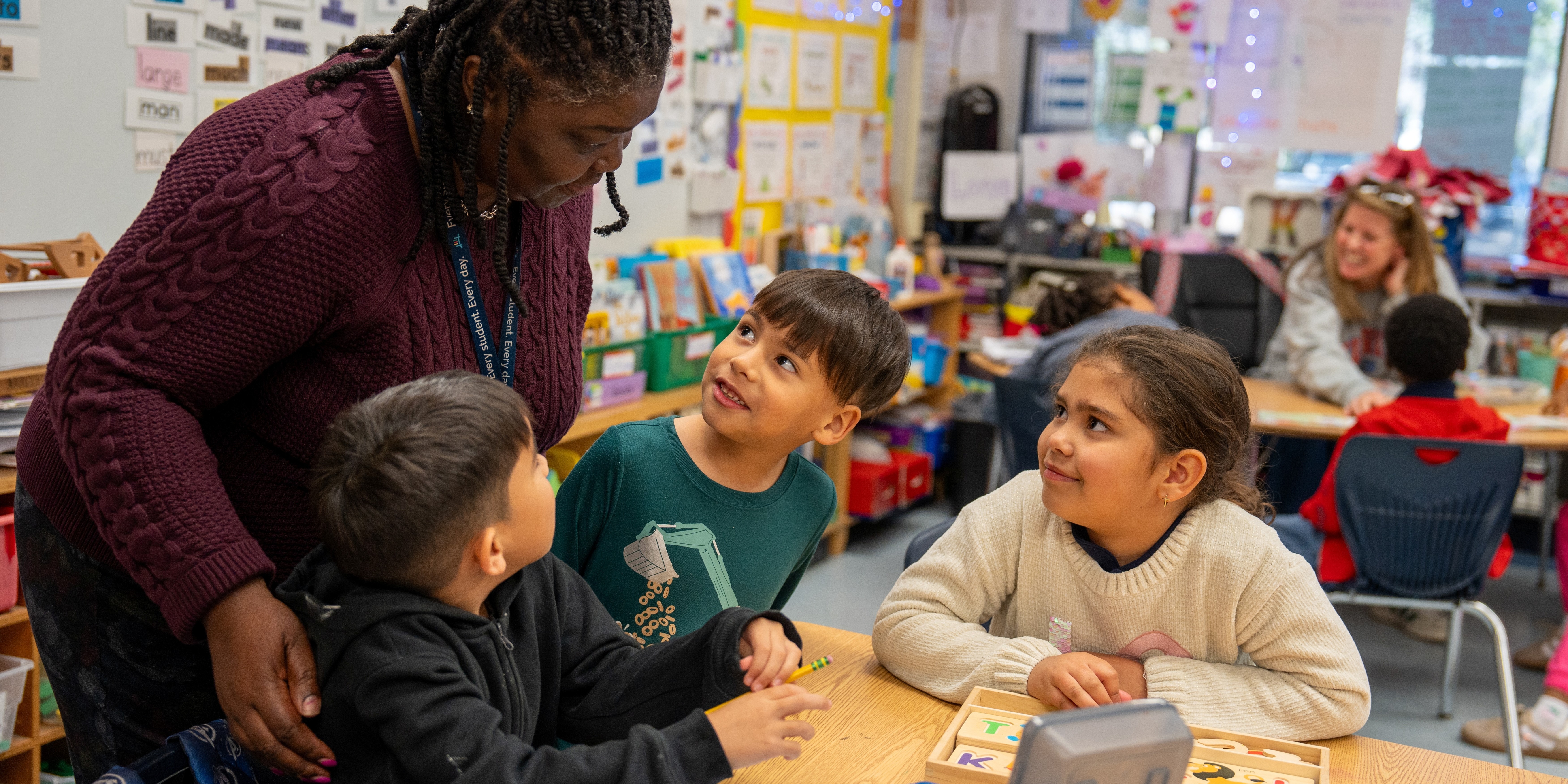 students in classroom listening to their principal