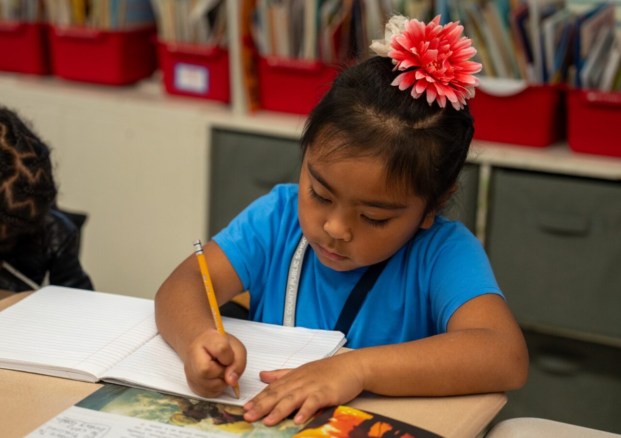 Student writing on her paper