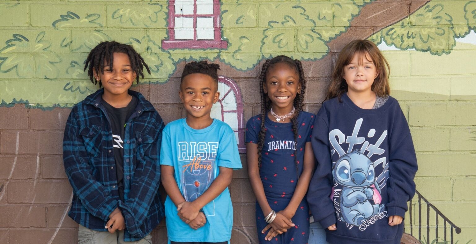 four students smiling together