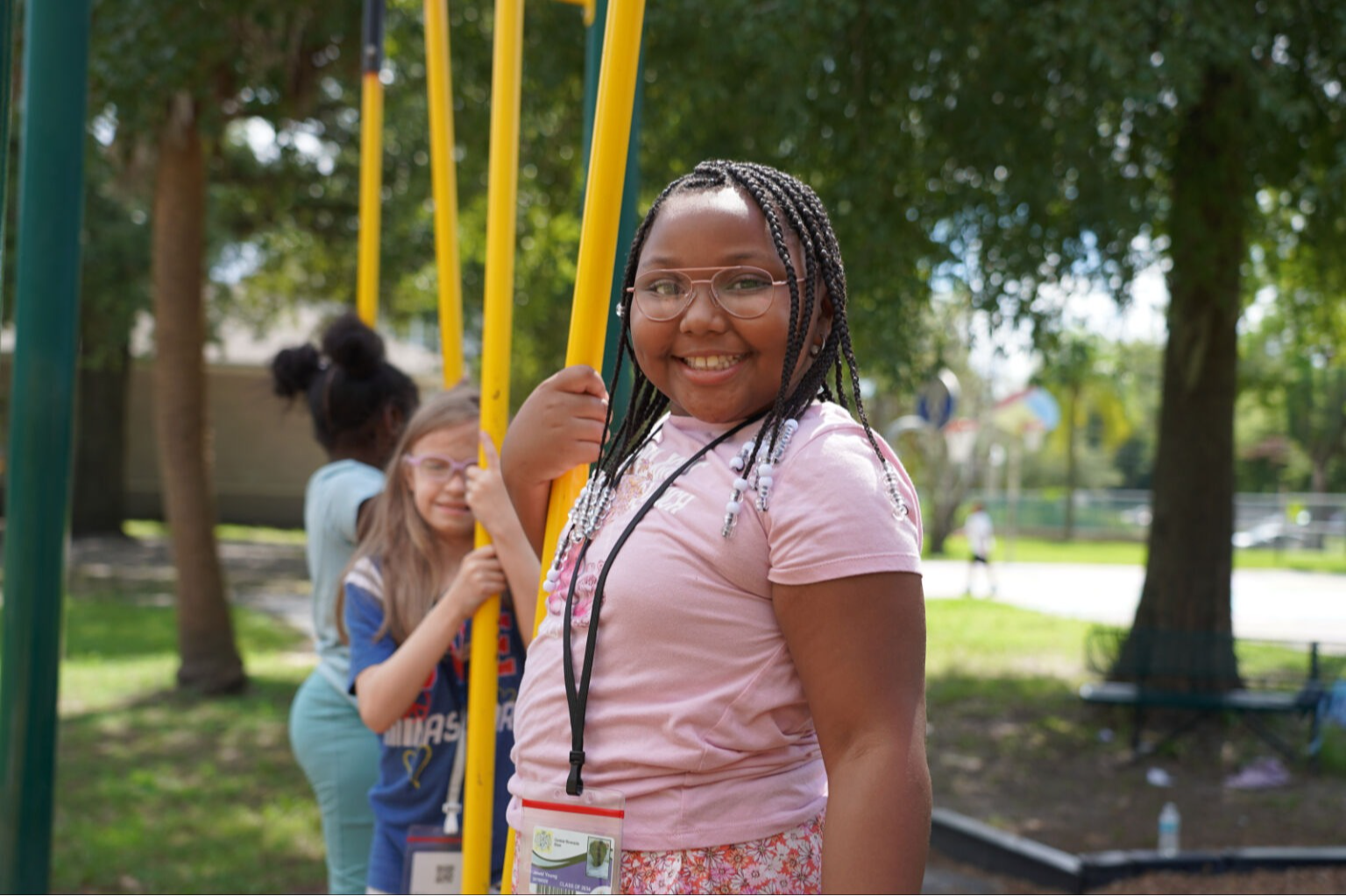 Student smiling at the camera on the playground