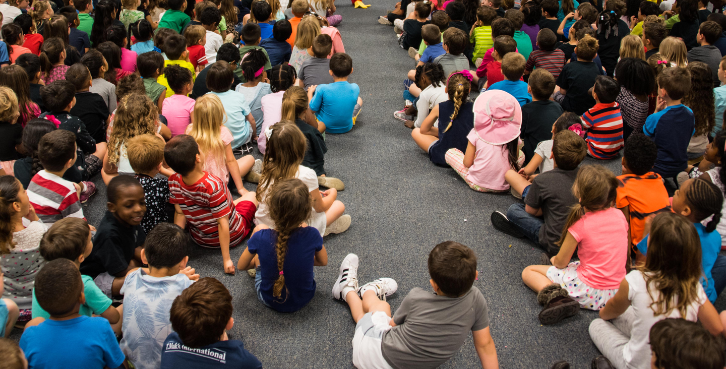 Students on the floor listening 