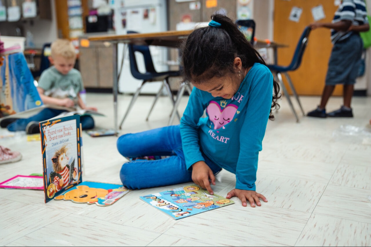 Student on the floor with books