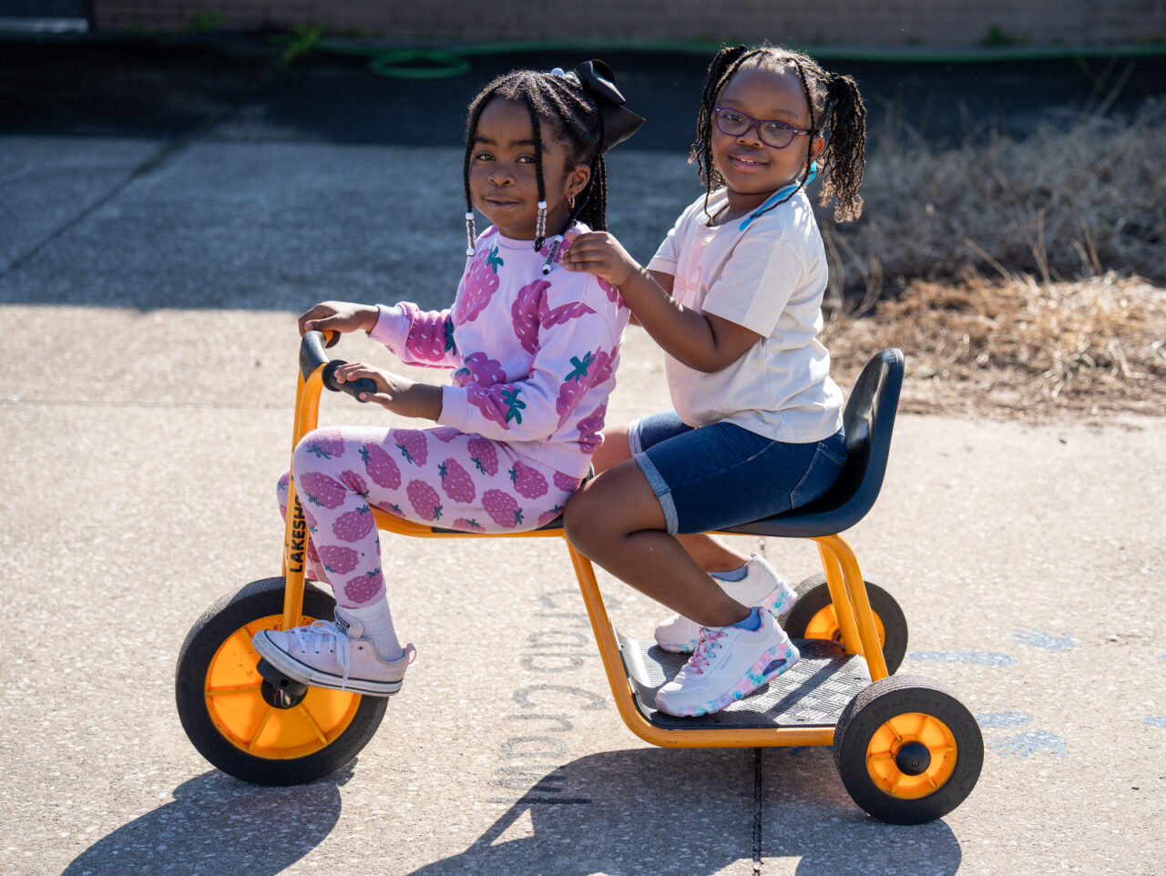 Two girls on a bike together