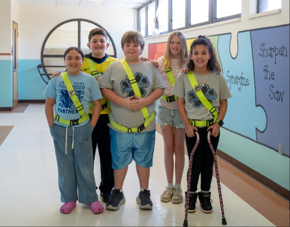 A group of safety patrols posing in the hallway. 