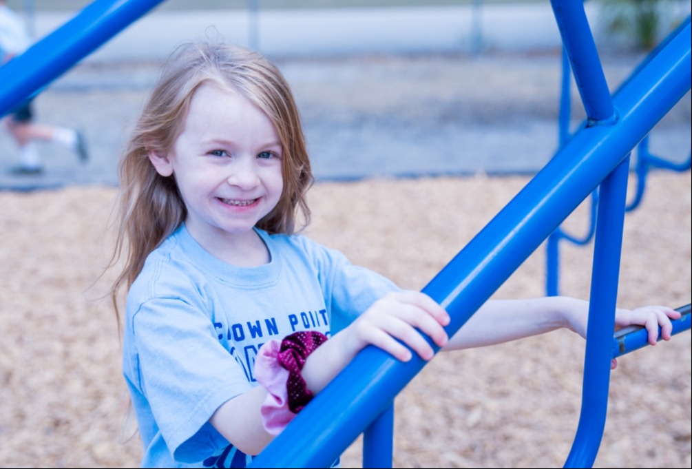 Student playing on the playground during afterschool care in Extended Day. 