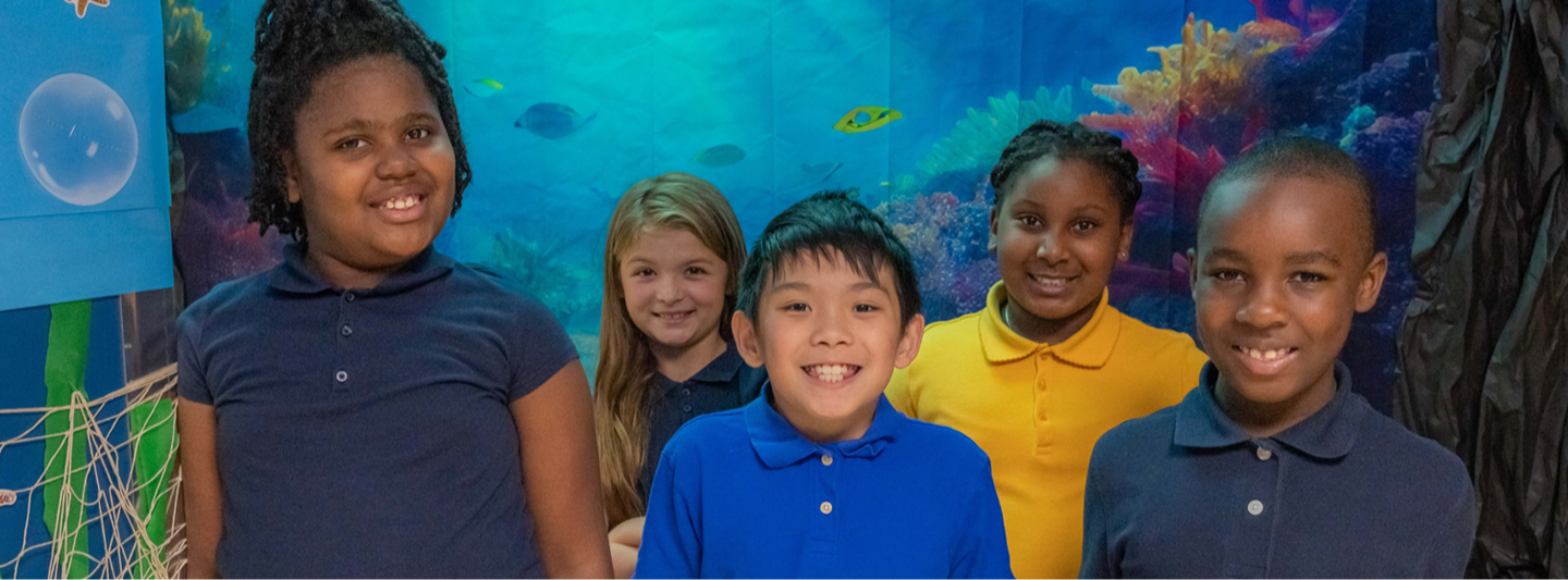 students with mural of fish