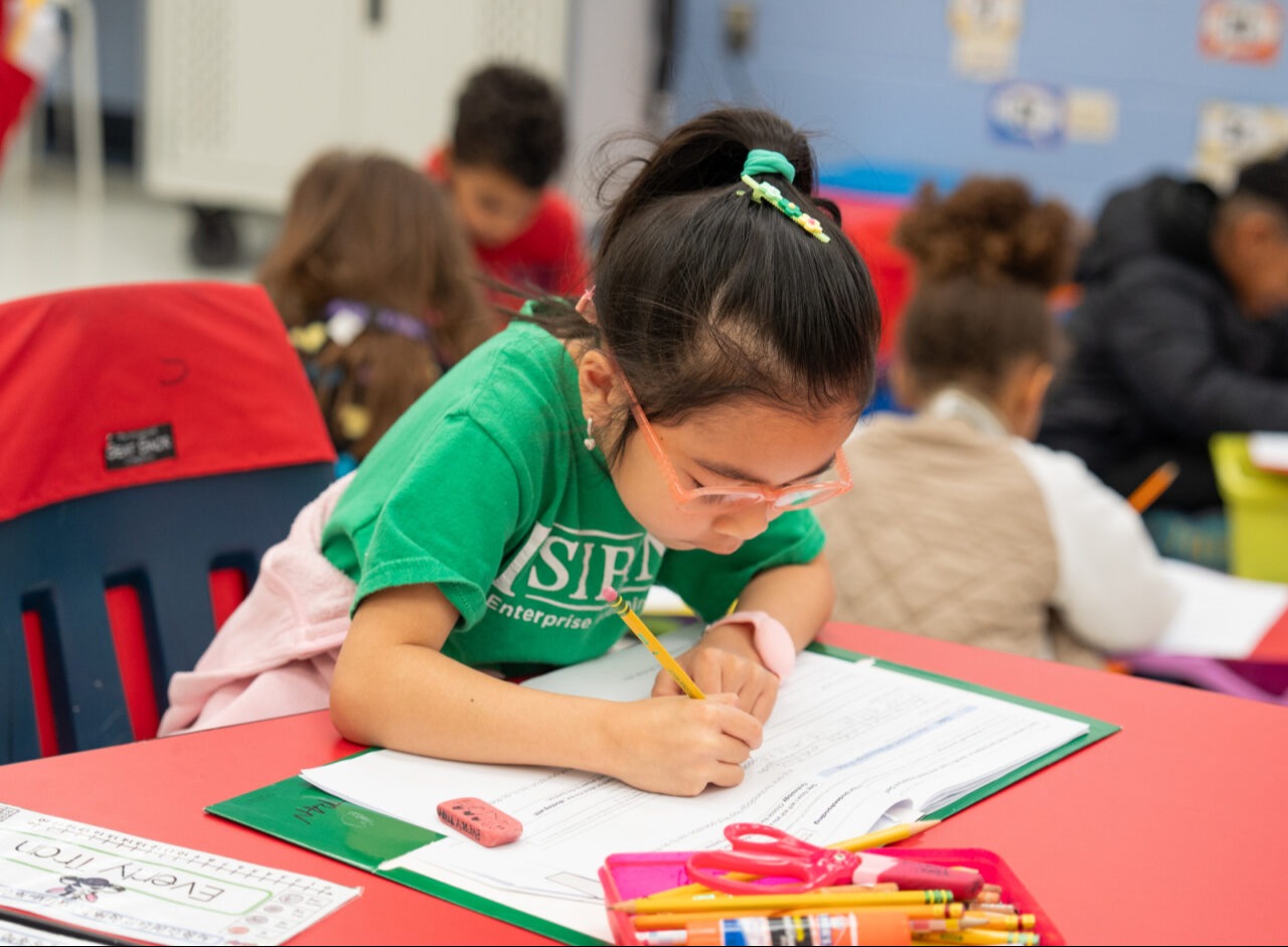 Student writing on a paper