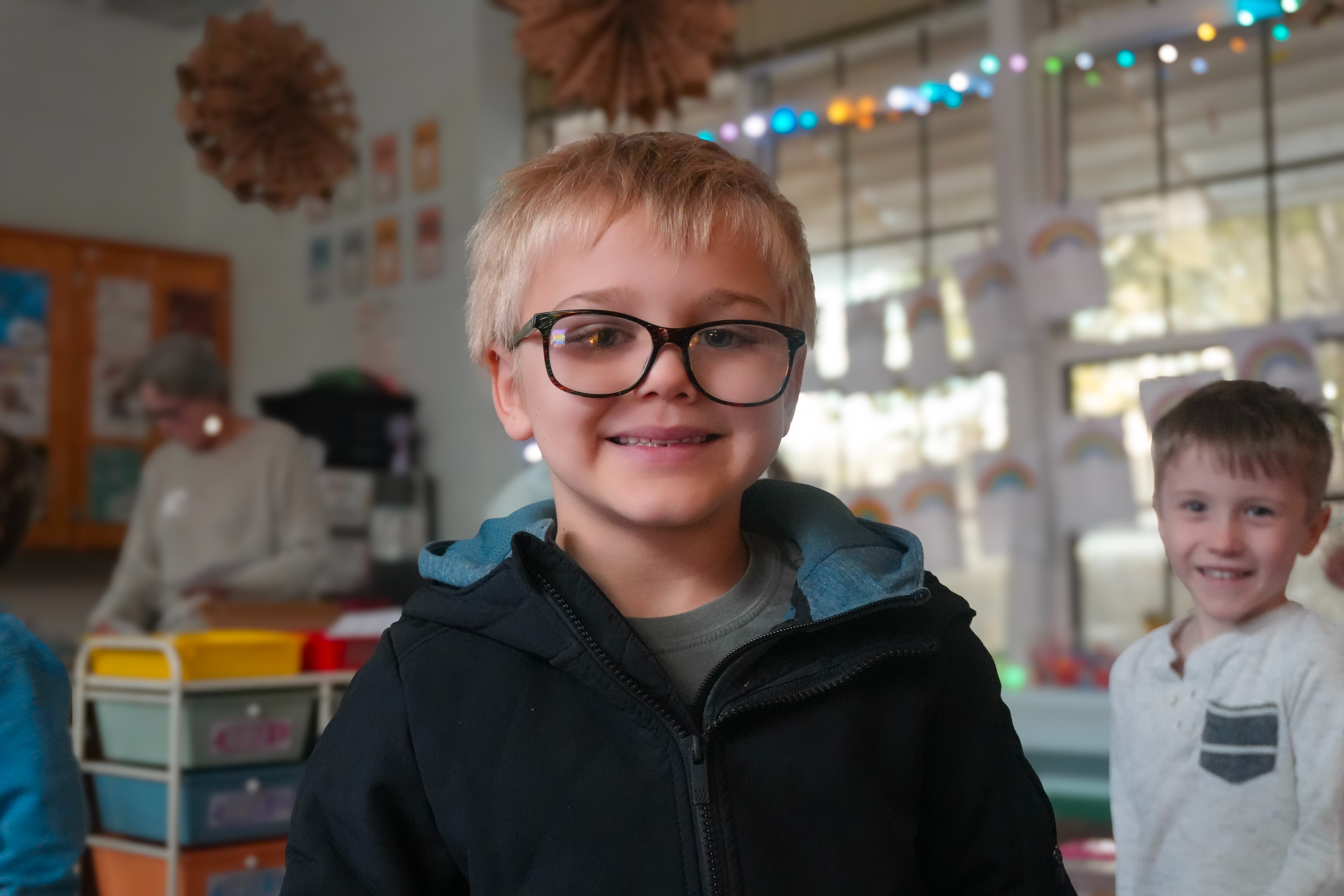 Student smiling with glasses on