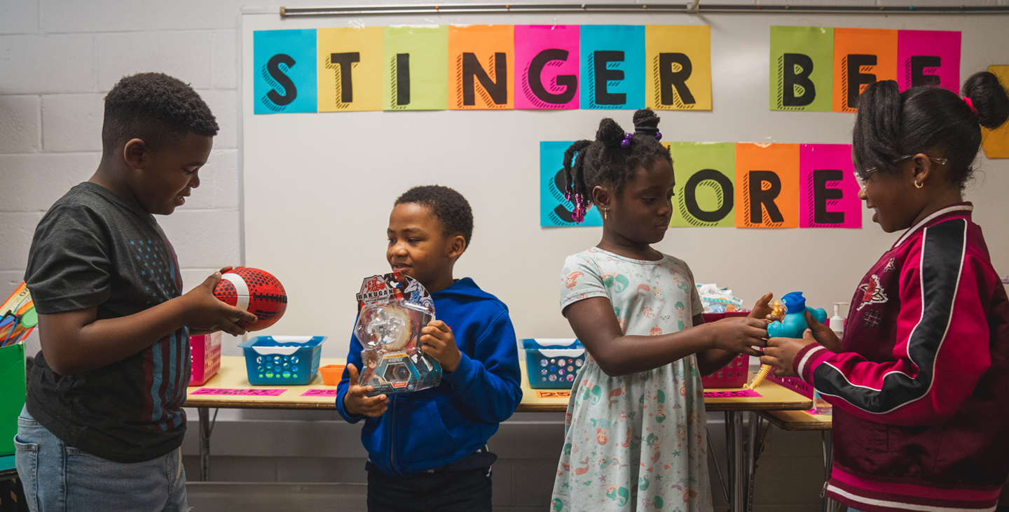 kids getting toys from the school store