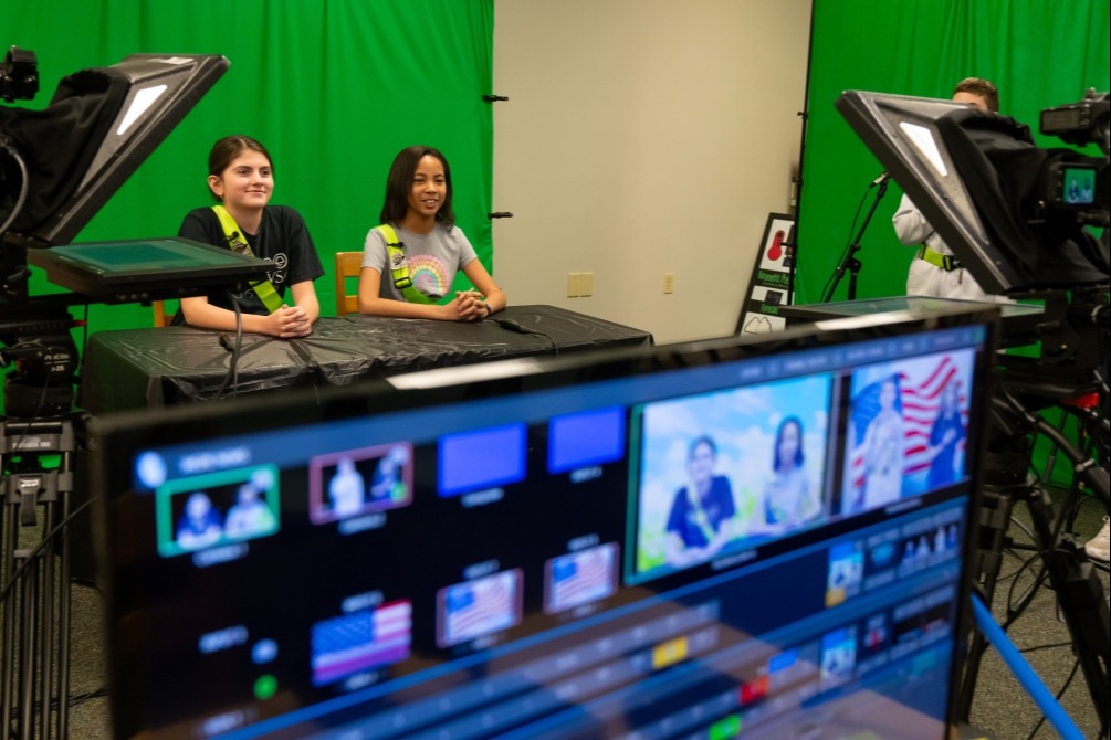 Students during live production of the morning Cougar News show.