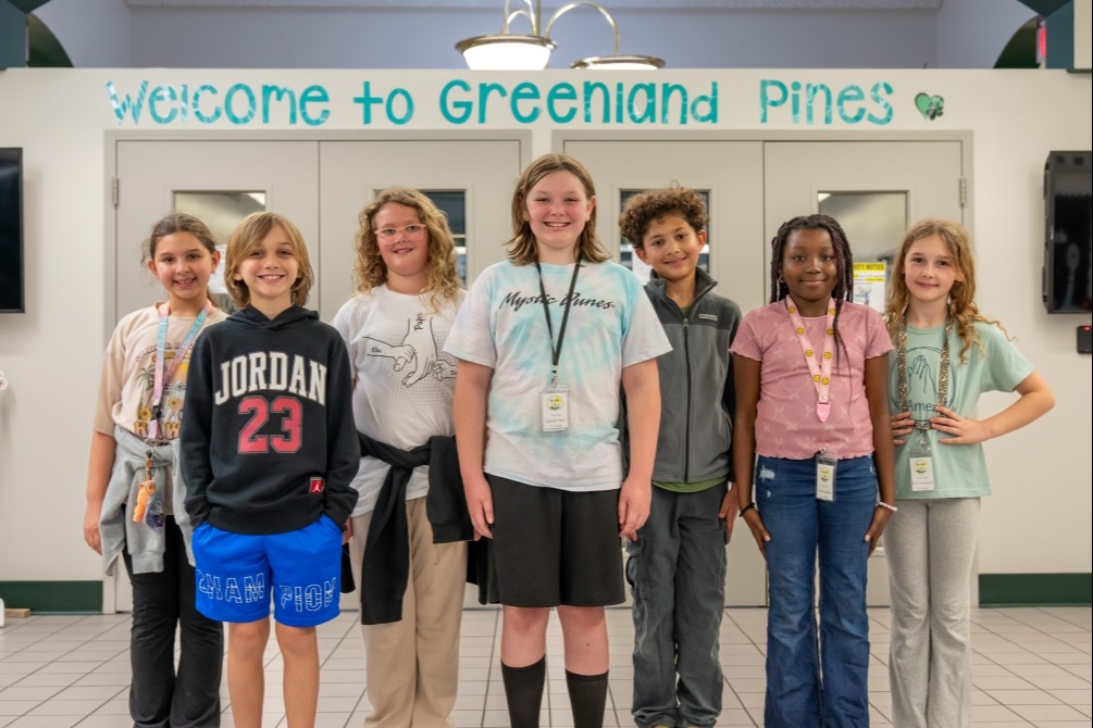 Top Cats students waiting to greet visitors to Greenland Pines Elementary.