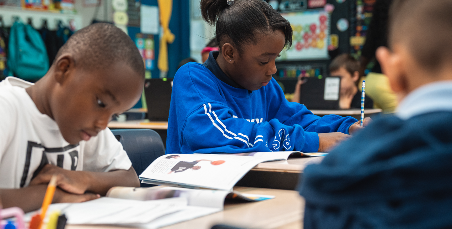 Students reading and writing at their desks