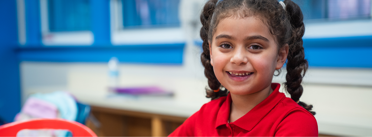 student smiling with red shirt