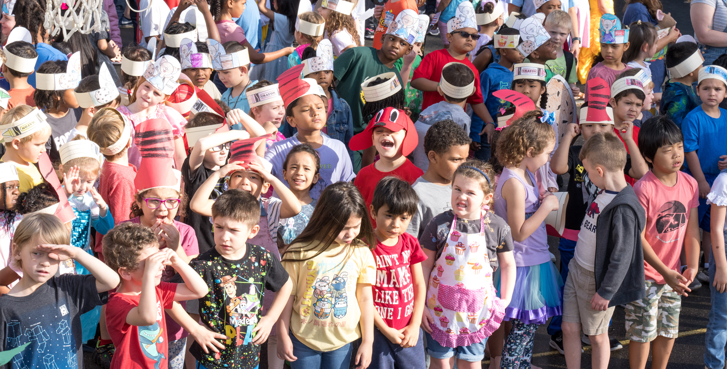 group of students wearing paper hats based on children's books