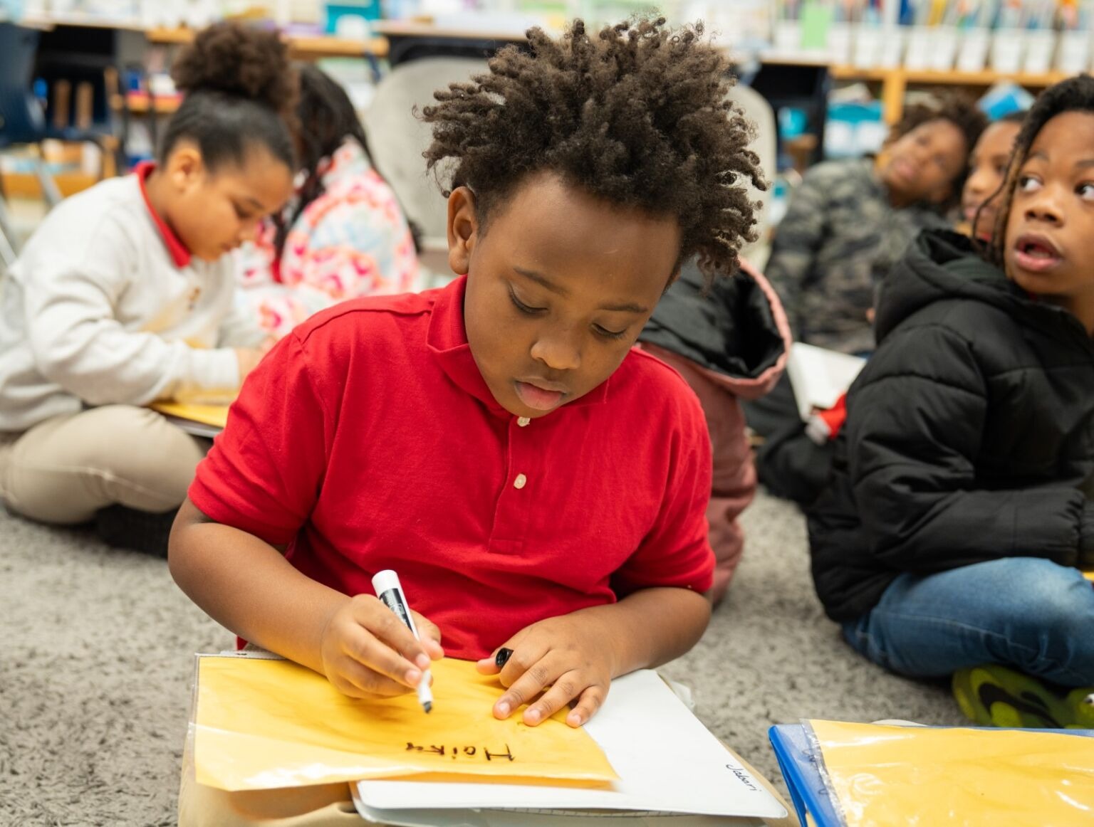 Student writing on a paper