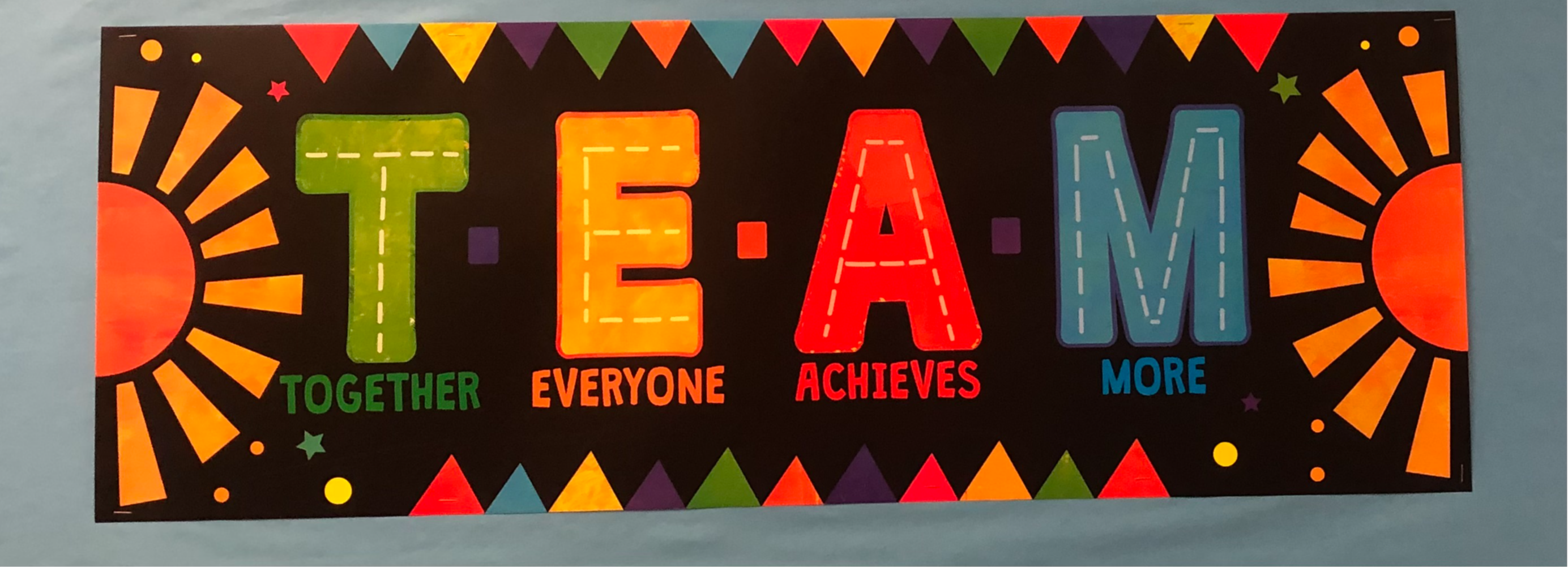 School Sign that says, "T*E*A*M, Together Everyone Achieves More."