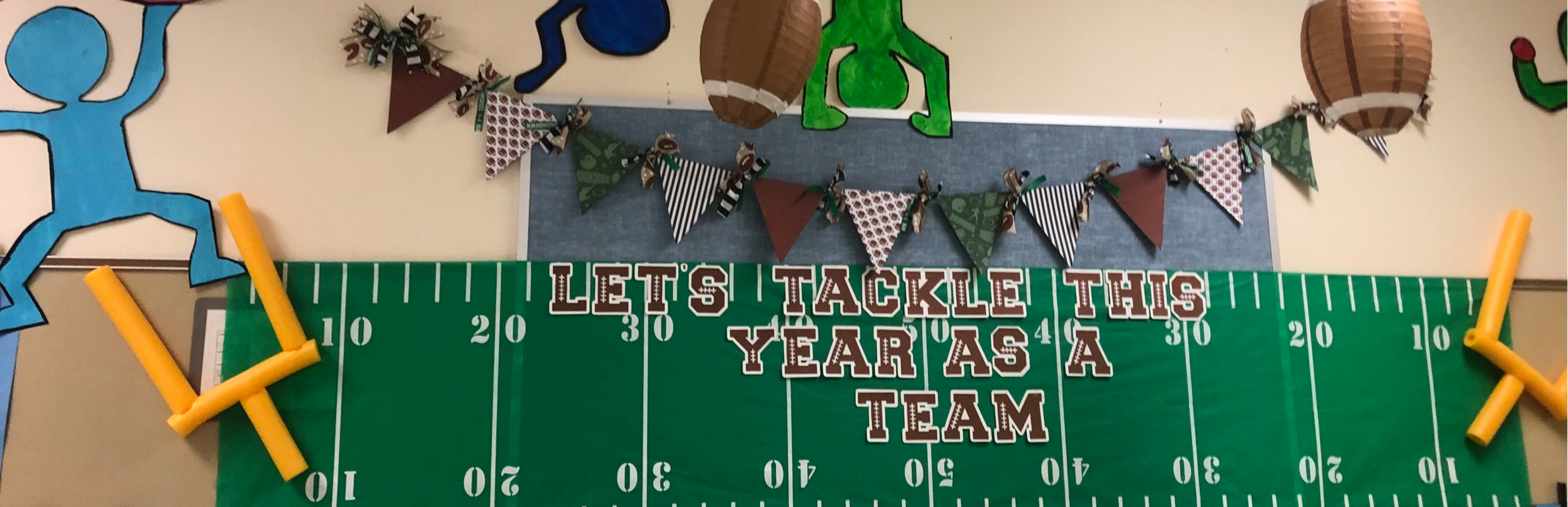 Wall Decoration that says, "Let's Tackle This Year as a Team."