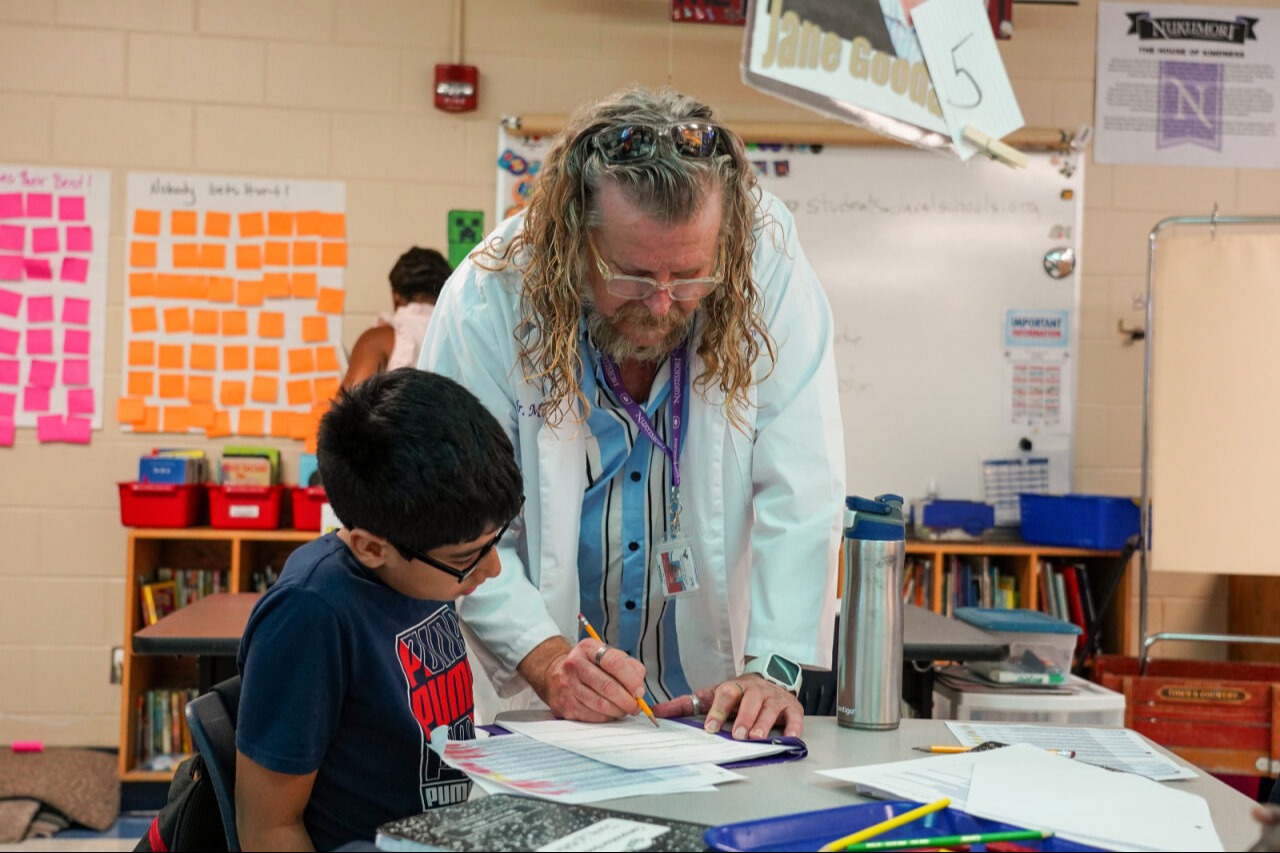 A teacher helping a student