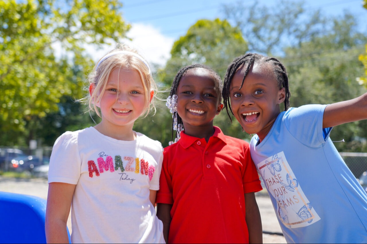 three students smiling together