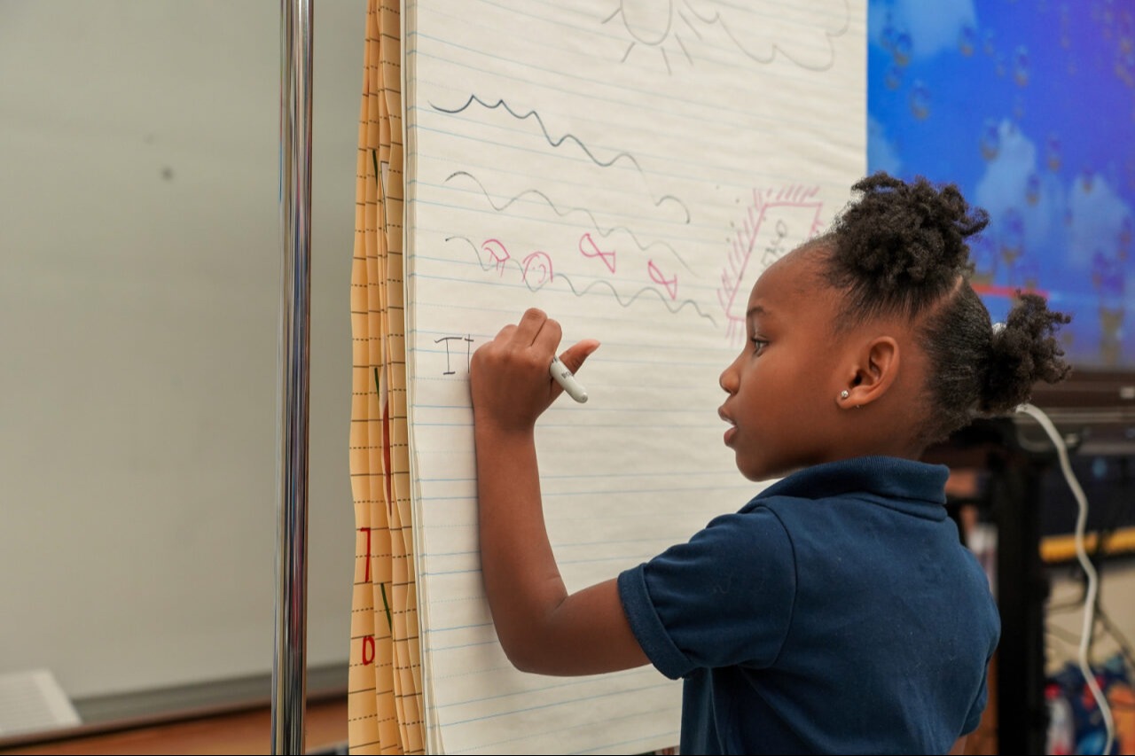 Student writing on the board