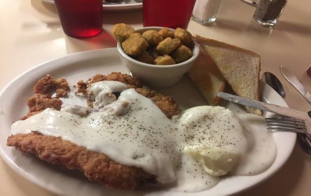 Picture of chicken fried steak with gravy, mashed potatoes, fried okra, and toast 