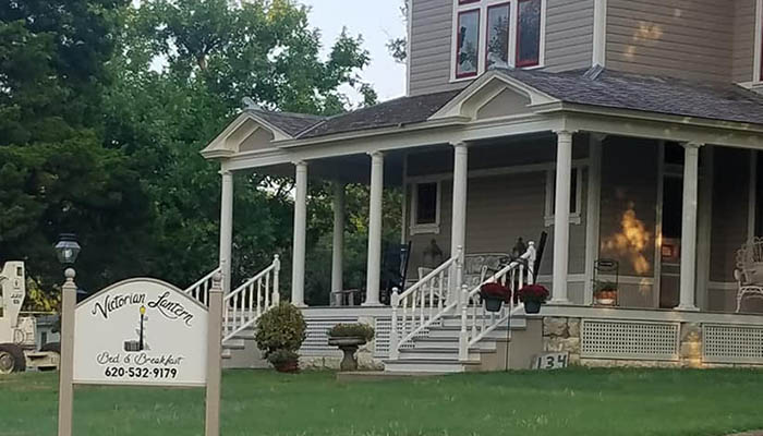 VICTORIAN LANTERN HOUSE WITH SIGN IN YARD 