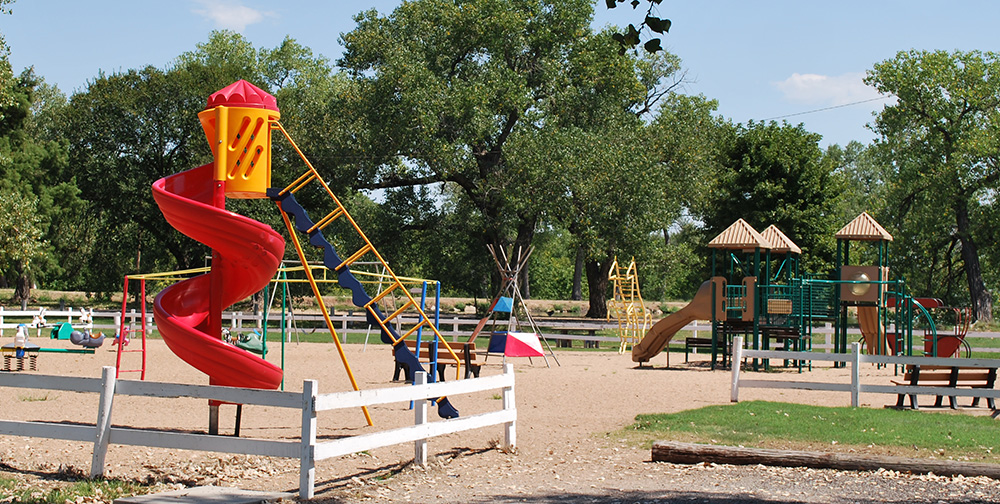 park with red and yellow spiral slide