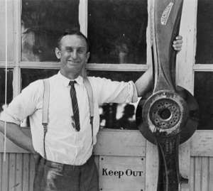 Emil Brown standing with airplane equipment 