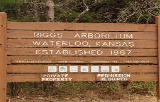 Wooden sign that reads Riggs Arboretum Waterloo, Kansas Established 1887 