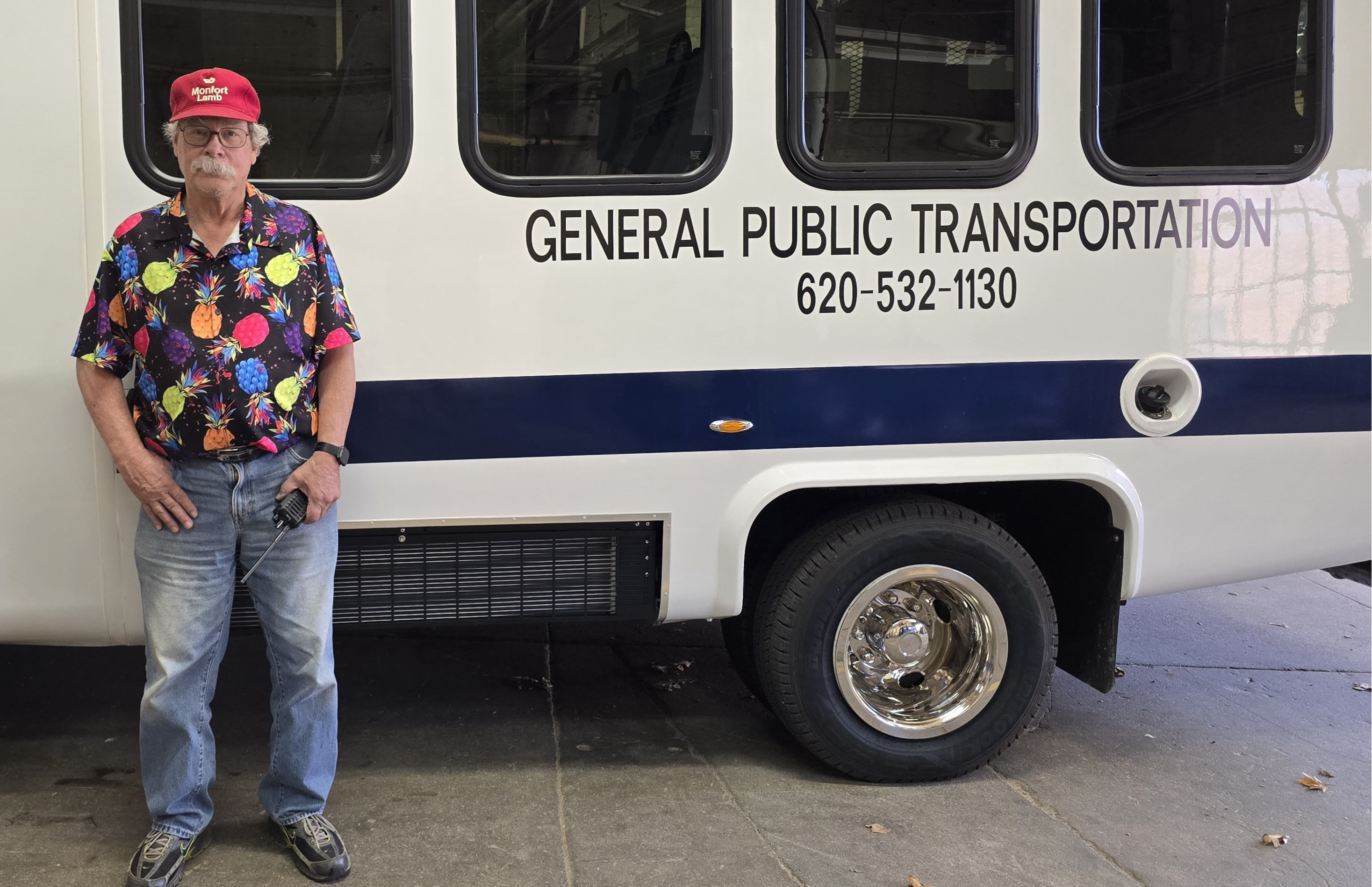 Driver Way Townsend standing next to bus 