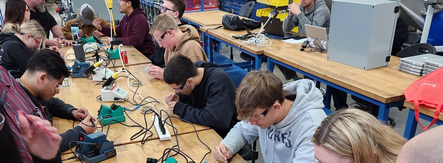 Students working on circuit boards. 