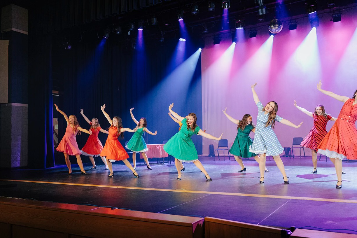 Students perform onstage. 