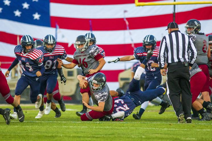 Football players compete on the field.