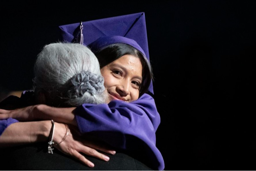 An MVHS graduate hugs her grandmother.